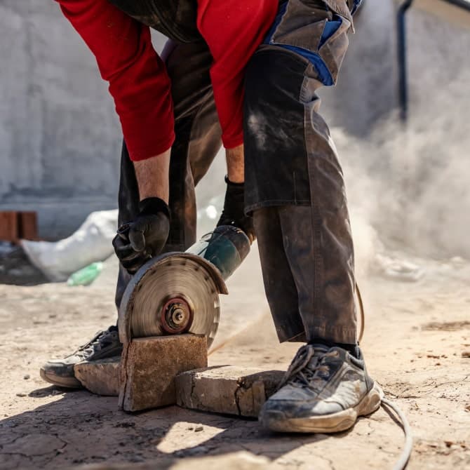 contractor using cutting machine to cut woods