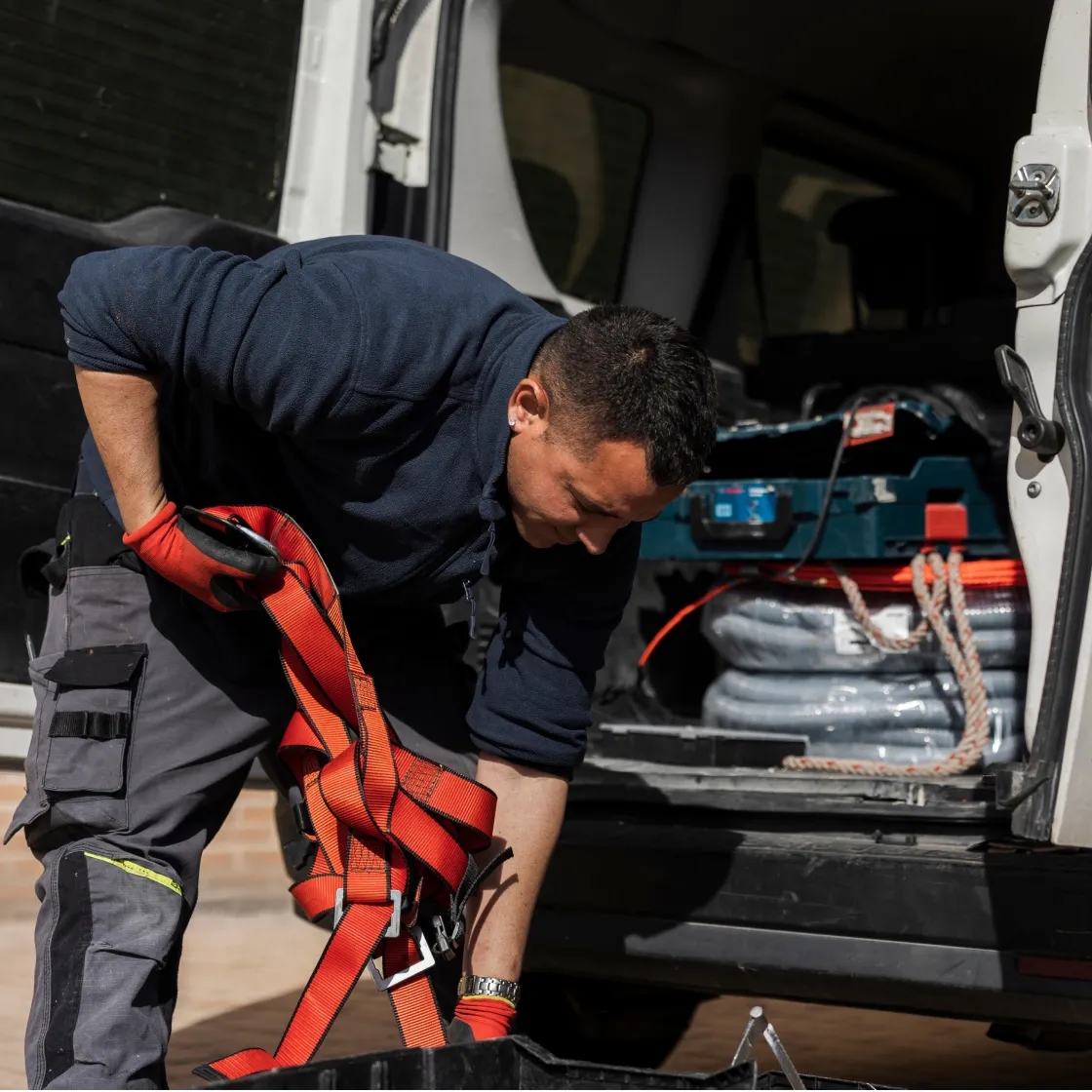 HVAC technician loading equipment